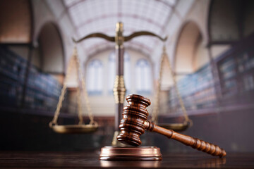 Law theme. Themis statue, scale and judge gavel in the law faculty library.