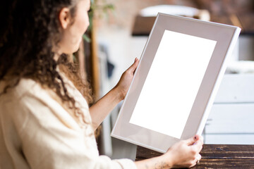 Mock up poster. Minimal template with empty picture frame mock up. Girl holding frame