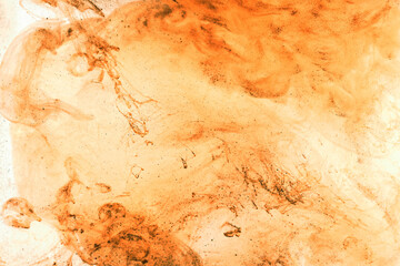 Liquid fluid art abstract background. Orange jets and smoke rings dancing acrylic paints underwater, space ocean, color explosion