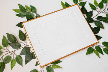 Mock up poster. Minimal template with empty picture frame mock up. White background with plants