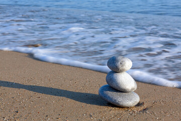 Fototapeta na wymiar Spa background with zen stones on beach.