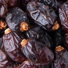 pile of fresh dates, closeup view of edible and tropical sweet fruits, background taken from above, macro