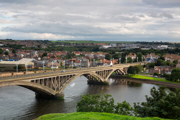 Fototapeta na wymiar Aerial view of the Bridge running through the border town of Berwick Upon Tweed with the A1167 road