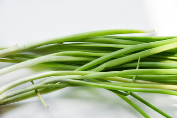 Green onions with bulbs on a white background.