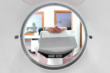 Unrecognizable woman into a ct scan machine in an hospital