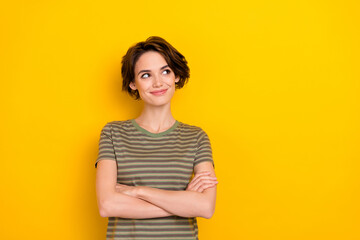 Obraz premium Portrait of young attractive woman wear striped khaki t-shirt folded hands thinking about weekend isolated on bright yellow color background