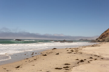 A view on Pacific ocean, cast, rocks and waves