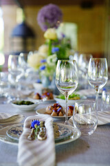 beautiful setting of a large table with snacks and flowers. 