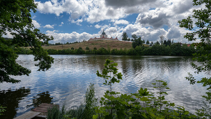 Zdar nad Sazavou, Czech Republic / Vysocina Region - 07 09 2022: Pilgrimage Church of St. John of Nepomuck with river and trees frame