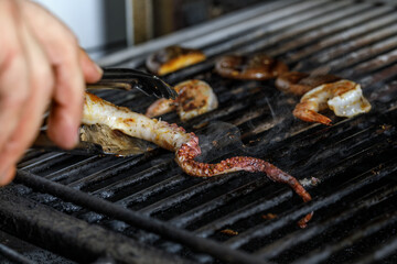 Process of grilling seafood on a barbecue grill over hot coal. Seafood recipes