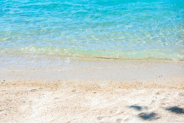 Summer beach background. Top view of white sand with tropical sea.