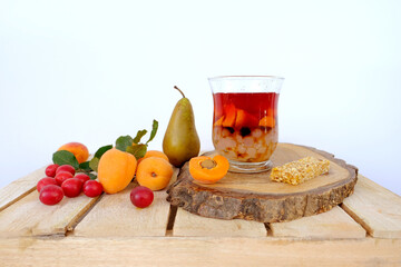 fresh juice fruit and berry low-calorie dessert in glass with bubble tea, ripe apricots, cherry plums, pears, muesli bar, concept of healthy eating, vegan diet, raw food, healthy food