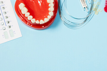 a set of special tools for an orthodontist to install braces for a patient. Orthodontic arcs, ligature, locks, positioner, tweezers