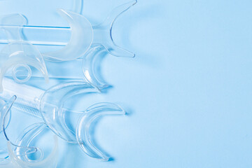 set of several Retractor Dental lip retractor Access to the oral cavity. Wide mouth opening for a dental procedure on a clean blue background