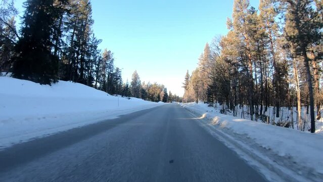 Crossing Nes mountain road Rukkedalvegen between Nesbyen and Langedrag in Norway - Highland road with snow during morning sunrise seen from car front