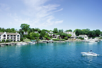 Lakefront homes and boats in the Round Lake in downtown Charlevoix Michigan