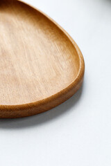 Empty wooden plate, dish, tray on kitchen white table. Empty and template mockup with place for...