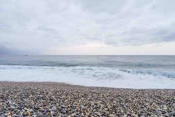 Beautiful scenic of ocean with sprawling stone covered beach.