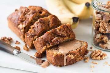 Fototapeta na wymiar Vegan gluten free Banana bread with walnuts cut into slices, closeup view