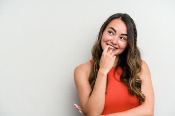 Young caucasian woman isolated on white background relaxed thinking about something looking at a copy space.