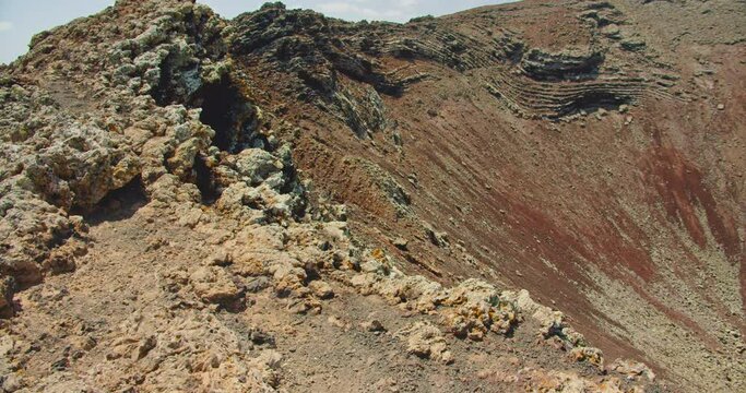 Slow motion of hardened lava flow on the slope of Volcano Calderon Hondo, Fuerteventura, Canary Islands. Crater desert empty landscape. Close up of rock formations.