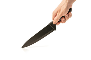 Knife in male hand isolated on white background. Kitchen knife in the hand of the chef. Copy space.