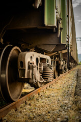 Fototapeta na wymiar Wheels of a freight train, a closeup view of train undercarriage