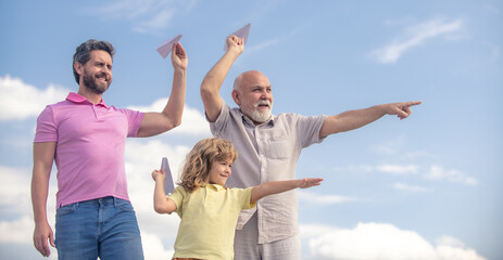 Fathers day. Kid having fun with toy plane. Men generation family with three different generations ages grandfather father and son. Weekend family play.