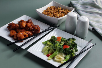 Chinese Food: orange chicken, stir-fried vegetables, and rice.