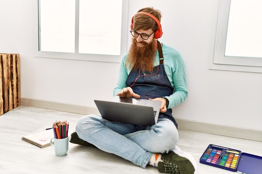 Young redhead man smiling confident having online draw class at art studio