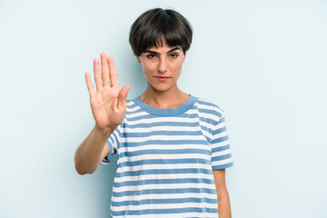 Young caucasian woman with a short hair cut isolated standing with outstretched hand showing stop sign, preventing you.