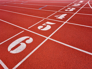 Red running tracks in the athletics stadium. Background image of empty tracks for running.