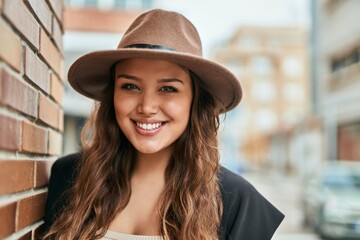 Young hispanic tourist woman smiling happy standing at the city.