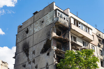 House in of civilians destroyed by russian army in the suburbs of Kyiv (Irpin). Traces on the building from shells. russia's war against Ukraine.