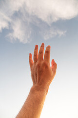 male hand reaching out in summer