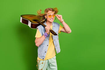 Photo of youngster guy wander musician hold guitar wear denim stylish jeans vest isolated bright color background