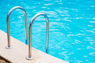 handrails of stairs for descent into the pool. the concept of summer holidays.