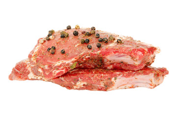 Beef steak marinated with spices on a white background.