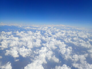 Fototapeta na wymiar beautiful view over the cloud and blue sky from air plane window