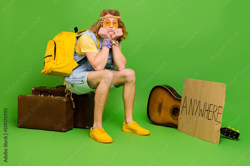 Poster photo of guy youth sit suitcase luggage feel bad no car hitching wear denim jeans vest isolated shin