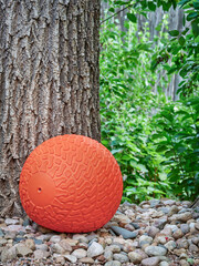 grooved and textured, heavy rubber slam ball filled with sand in a backyard, exercise and functional fitness concept