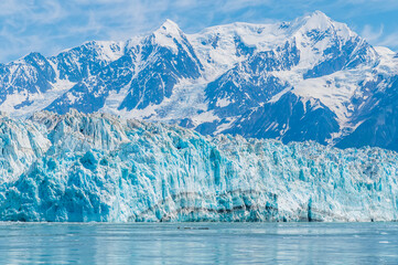 A close up view towards the snout of the Hubbard Glacier with mountain backdrop in Alaska in summertime