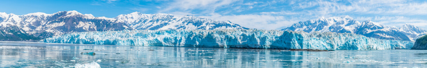 Fototapeta na wymiar A panorama view past floating ice in Disenchartment Bay towards in the Hubbard Glacier, Alaska in summertime