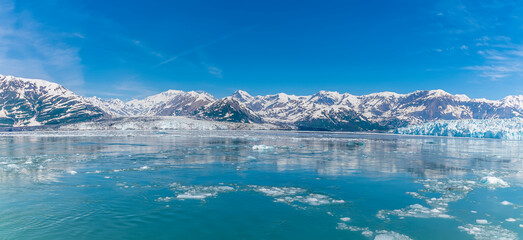 A panorama view past floating ice in Disenchartment Bay towards in the Valerie and Hubbard Glacier,...