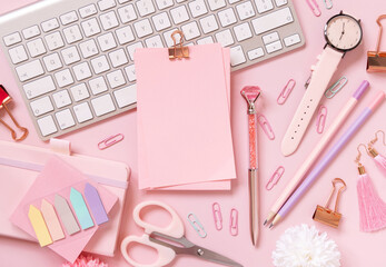 Paper with a clip, Pink school girly accessories and keyboard on pastel pink Top view, mockup