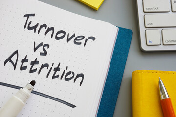 Turnover vs attrition words in the notepad and marker.