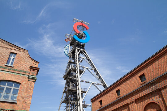 Silesia City Center shopping mall, located on the site of former coal mine KWK Gottwald. SCC logo sign at antique tower shaft Jerzy on July 21, 2022 in Katowice, Poland.