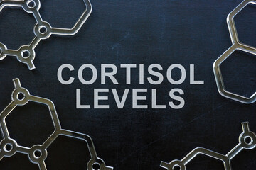 Cortisol levels phrase on the blackboard and molecule models.