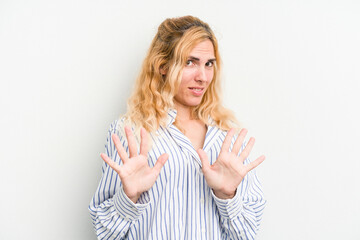 Young caucasian woman isolated on white background rejecting someone showing a gesture of disgust.