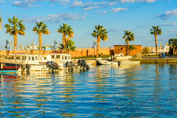White luxury yachts in a sea harbor of Hurghada, Egypt. Marina with tourist boats on Red Sea